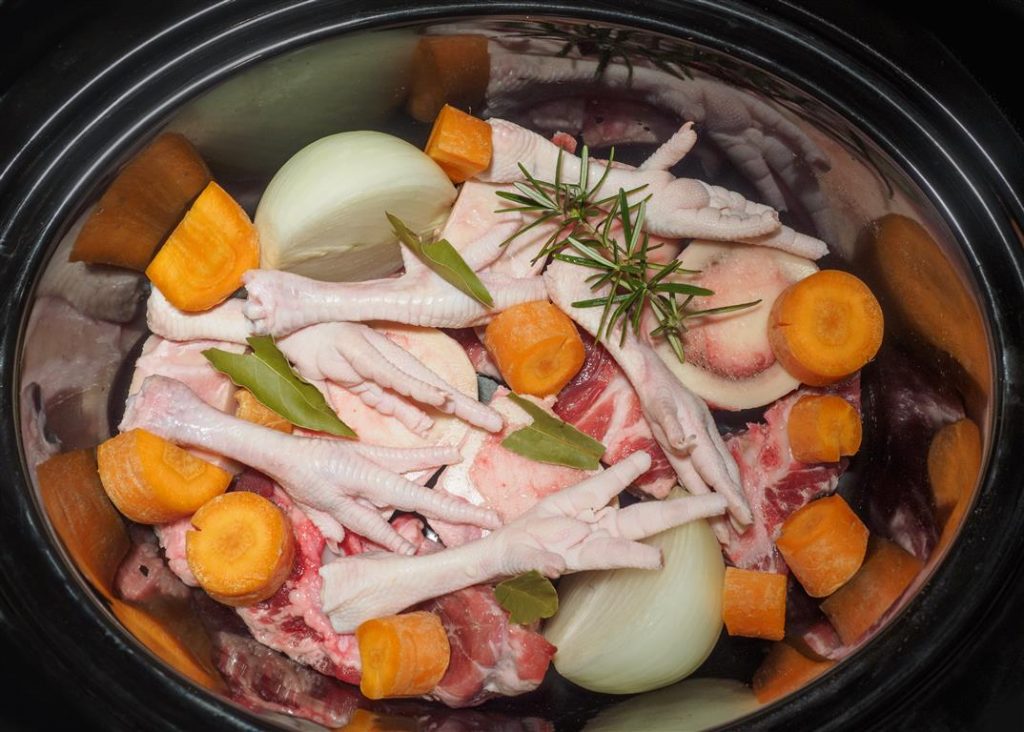 Bone broth ingredients in a slow cooker, ready for cooking